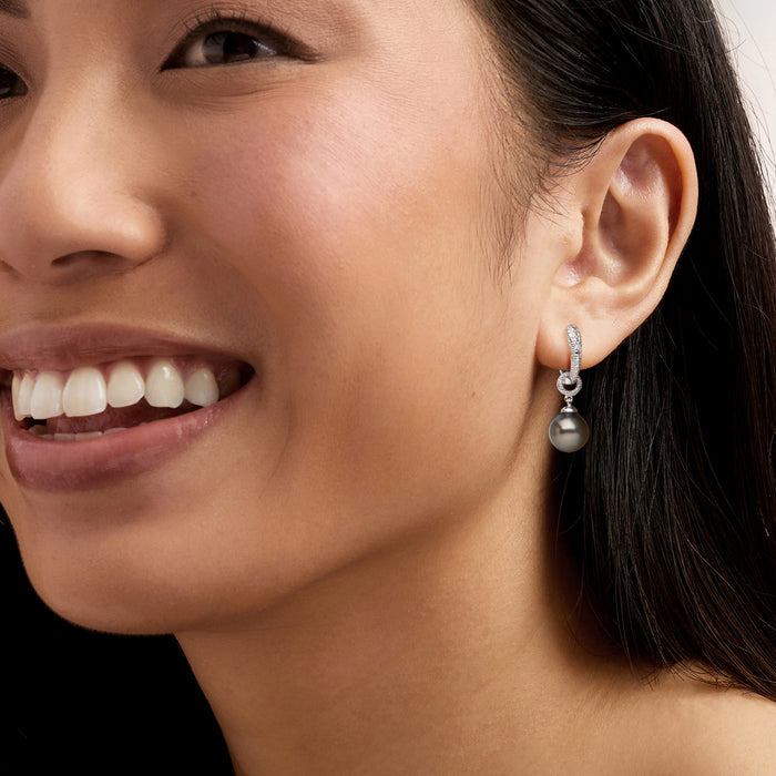 Sterling silver hoop drop earrings with diamond accents and iridescent Tahitian pearl on model