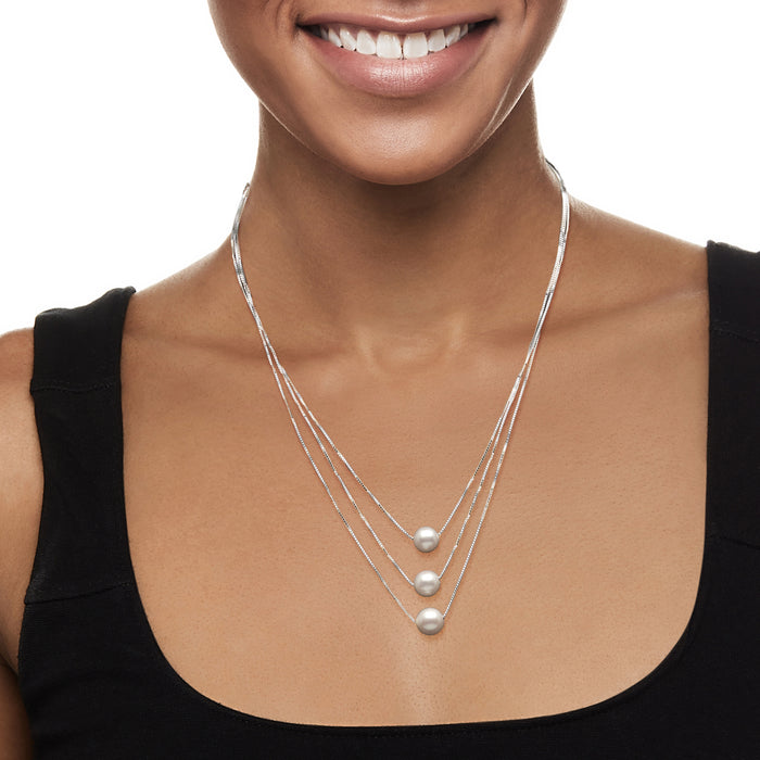 Three-strand layered cultured pearl necklace with three round white pearls on sterling silver