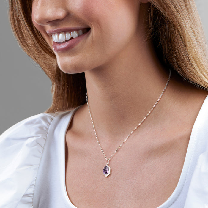 Sterling silver pendant necklace with purple amethyst CZ drop, worn on neck