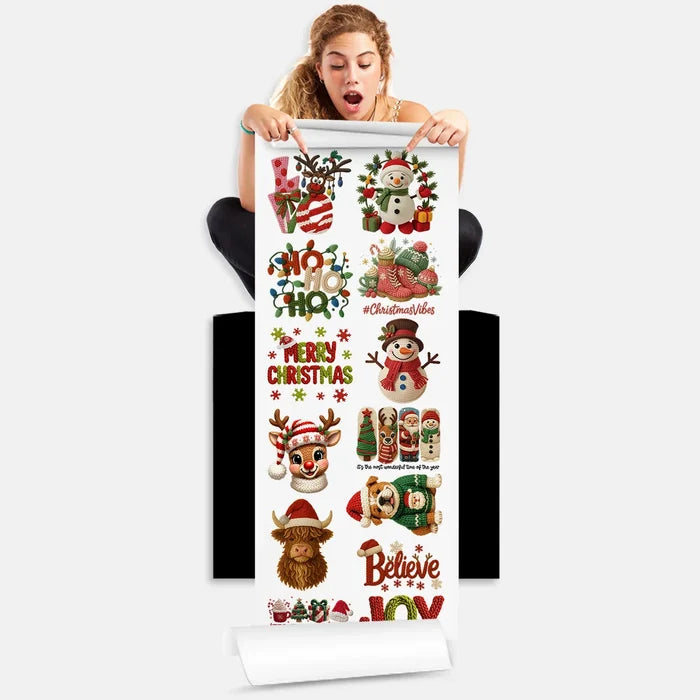 Person holding Yarn Christmas DTF Transfer gang sheet with 13 holiday designs featuring snowmen, reindeer, and festive text