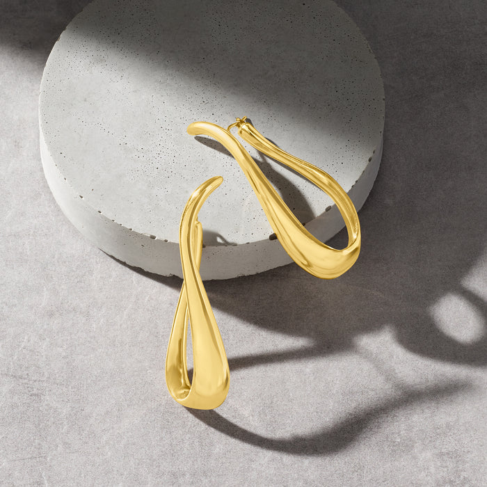 Twisted gold hoop earrings with open back, glossy teardrop loop profile