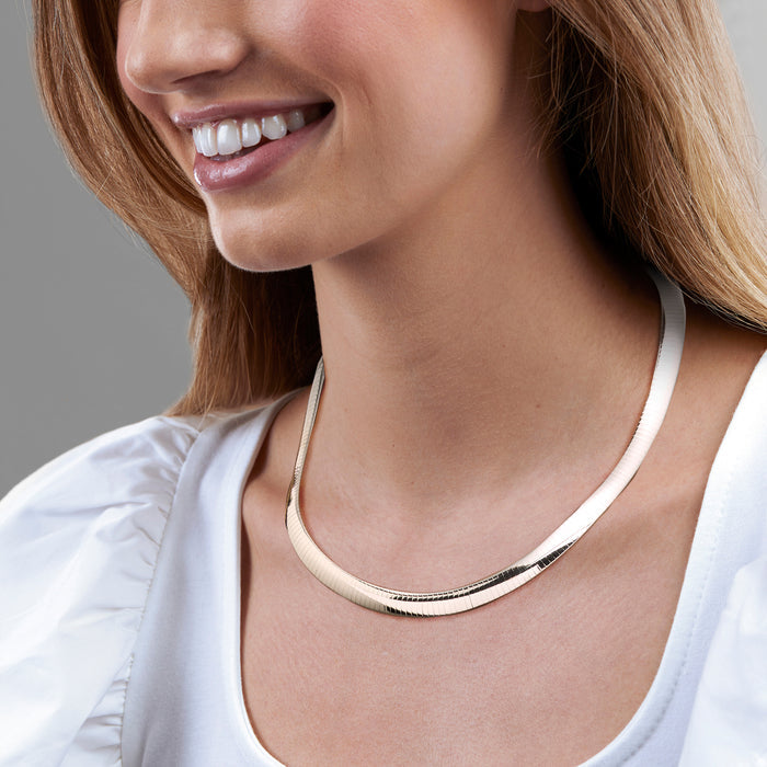 Sterling silver omega chain necklace on model, ribbed links with smooth clasp